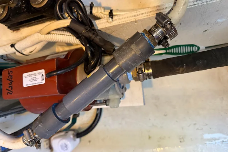 Long Gone Yacht Photos Pics Engine compartment of a 2013 Carver C34 with visible hoses and clamps.