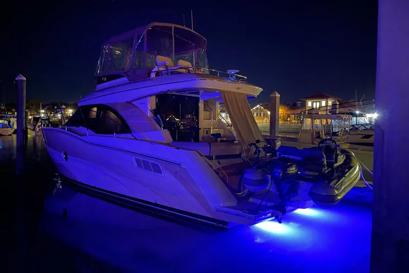 Long Gone Yacht Photos Pics 2013 Carver C34 yacht docked at night with blue underwater lights.