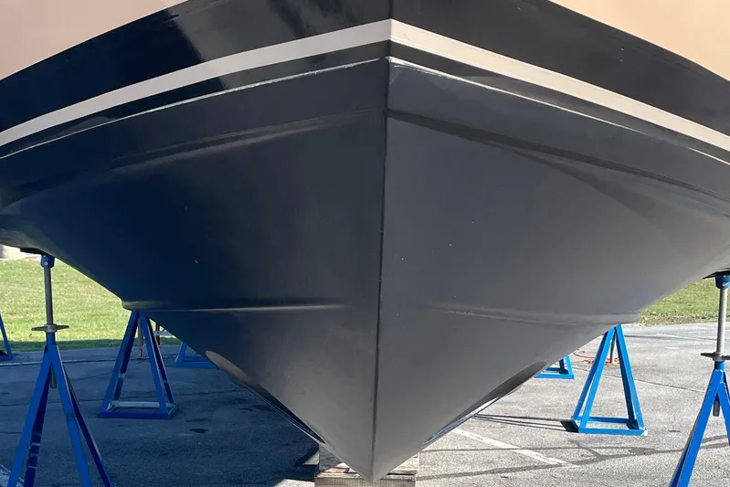 Long Gone Yacht Photos Pics 2013 Carver C34 boat hull on stands, showcasing sleek design and craftsmanship.