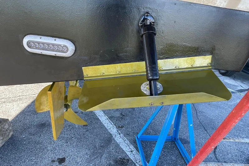 Long Gone Yacht Photos Pics 2013 Carver C34 boat propeller and trim tab on a stand.