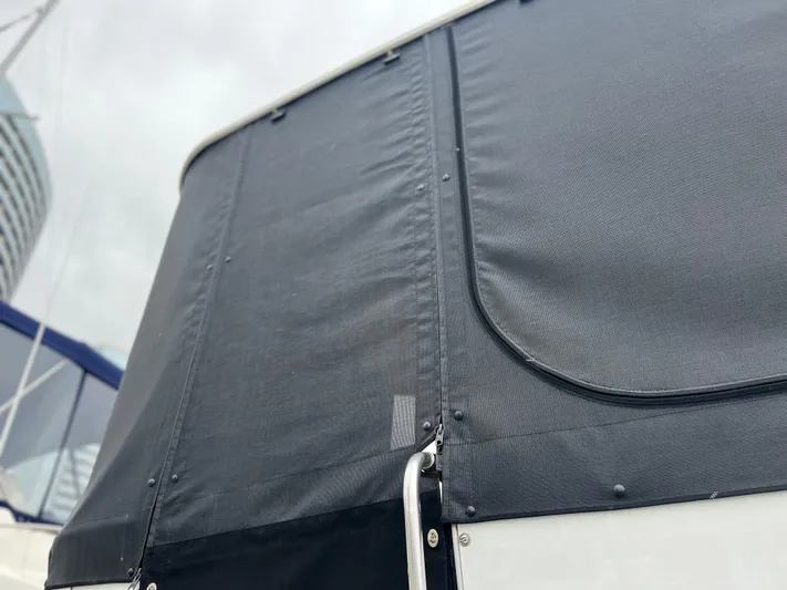 Low Engine Hours Yacht Photos Pics 1995 Cruisers Yachts 3650 ACMY with black canvas cover, close-up view.