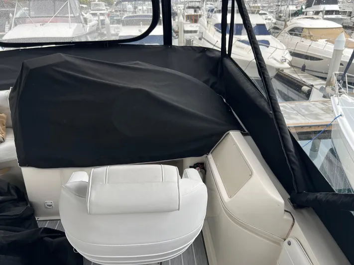 Low Engine Hours Yacht Photos Pics 1995 Cruisers Yachts 3650 ACMY interior with white seating and marina view.