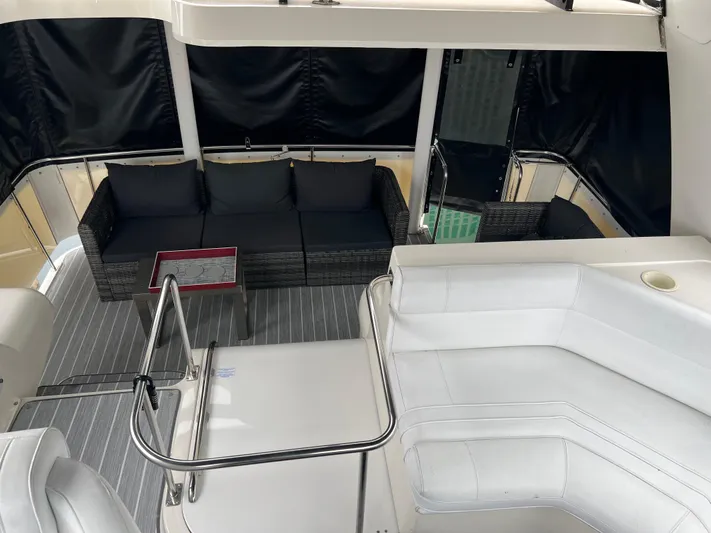 Low Engine Hours Yacht Photos Pics 1995 Cruisers Yachts 3650 ACMY interior with white seating and black cushions.