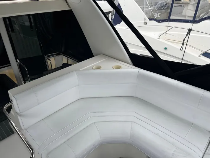 Low Engine Hours Yacht Photos Pics 1995 Cruisers Yachts 3650 ACMY interior with white seating and cup holders.