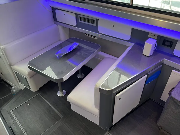 Low Engine Hours Yacht Photos Pics 1995 Cruisers Yachts 3650 ACMY interior with modern seating and ambient lighting.