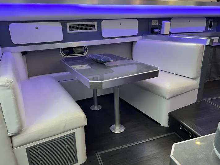 Low Engine Hours Yacht Photos Pics 1995 Cruisers Yachts 3650 ACMY interior with modern dining area and ambient lighting.