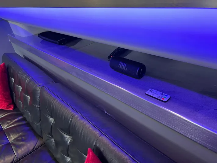 Low Engine Hours Yacht Photos Pics Luxurious interior of 1995 Cruisers Yachts 3650 ACMY with blue LED lighting and leather seating.