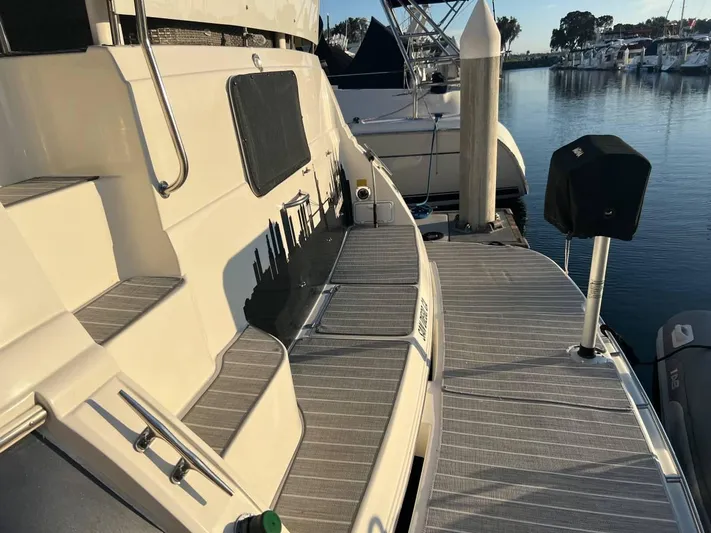 Low Engine Hours Yacht Photos Pics 1995 Cruisers Yachts 3650 ACMY docked at marina, showcasing deck and surroundings.