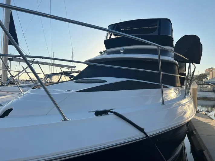 Low Engine Hours Yacht Photos Pics 1995 Cruisers Yachts 3650 ACMY docked at marina, sleek design, sunset lighting.