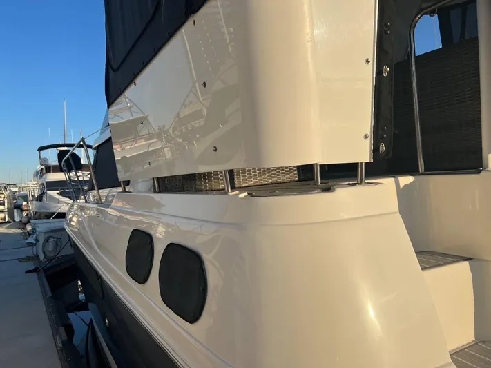 Low Engine Hours Yacht Photos Pics 1995 Cruisers Yachts 3650 ACMY docked, showcasing sleek design and modern features.