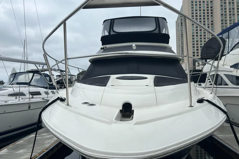 Low Engine Hours Yacht Photos Pics 1995 Cruisers Yachts 3650 ACMY docked, showcasing sleek design and spacious deck.