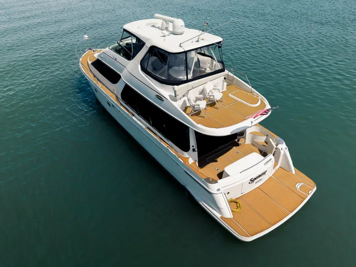 Spencer Yacht Photos Pics 2003 Carver Voyager yacht on calm blue water, aerial view.