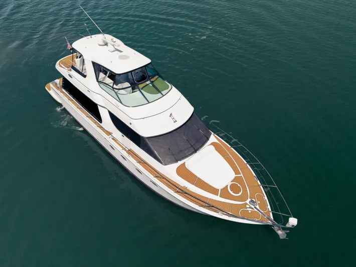 Spencer Yacht Photos Pics 2003 Carver Voyager yacht cruising on calm blue waters.