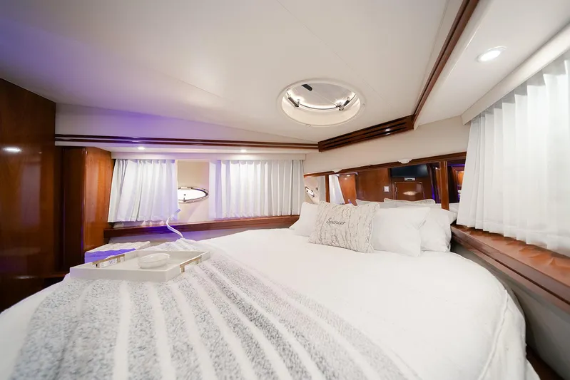 Spencer Yacht Photos Pics Luxurious bedroom interior of 2003 Carver Voyager yacht with elegant bedding and wood accents.