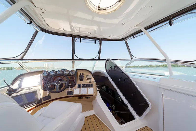 Spencer Yacht Photos Pics Interior of 2003 Carver Voyager yacht cockpit with steering wheel and navigation instruments.
