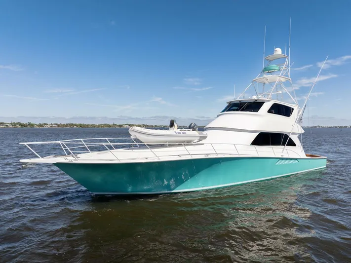 Berry Blessed Yacht Photos Pics 2005 Viking 74' Enclosed Bridge yacht on open water, featuring sleek design and vibrant hull.