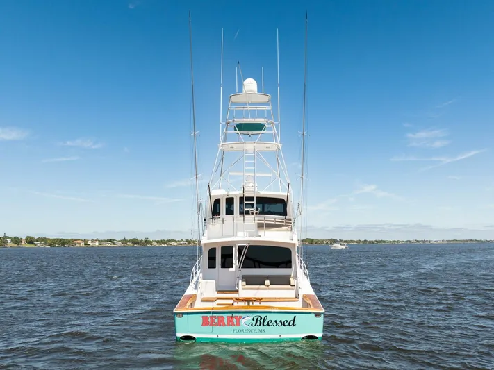 Berry Blessed Yacht Photos Pics 2005 Viking 74' Enclosed Bridge yacht on open water, rear view.