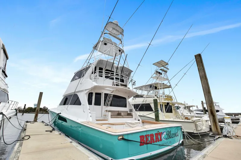 Berry Blessed Yacht Photos Pics 2005 Viking 74' Enclosed Bridge yacht docked at marina, clear sky background.