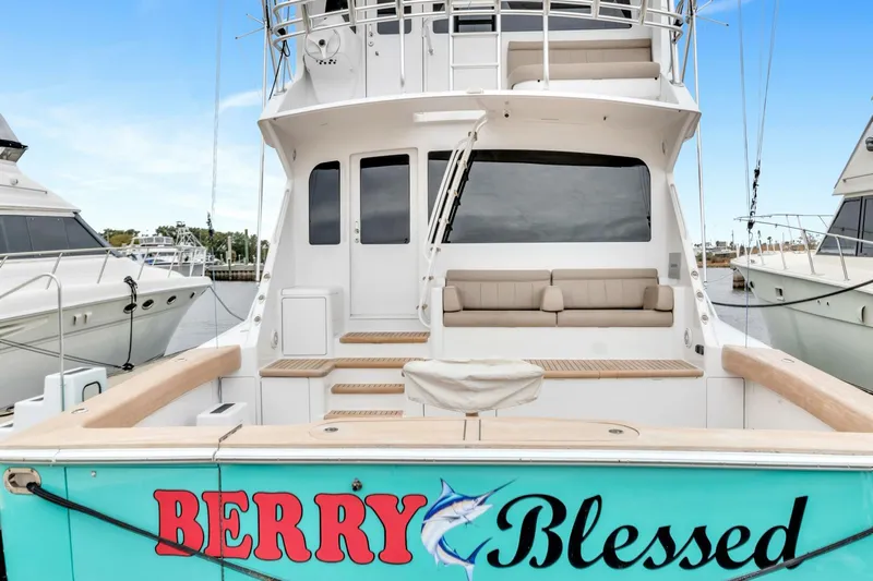 Berry Blessed Yacht Photos Pics 2005 Viking 74' Enclosed Bridge yacht, rear view, docked, with "Berry Blessed" name.