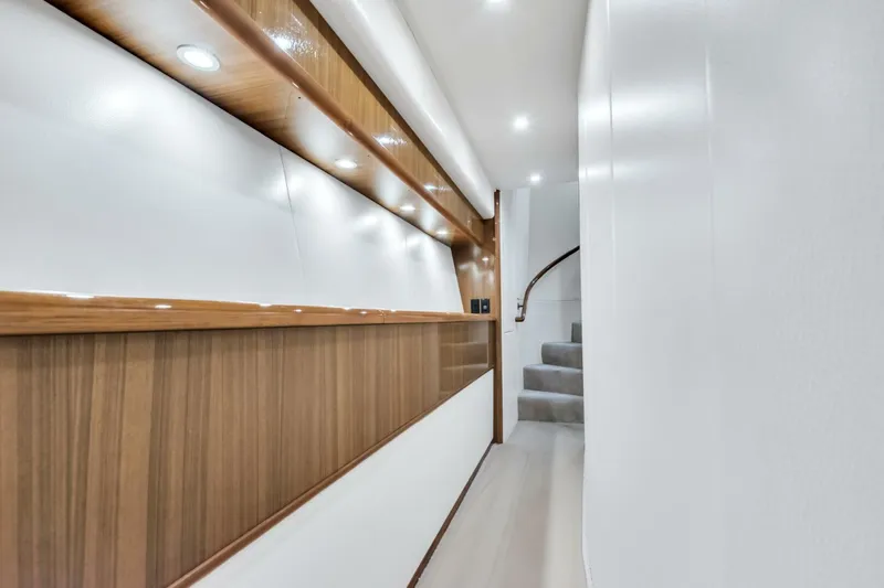 Berry Blessed Yacht Photos Pics Hallway of 2005 Viking 74' Enclosed Bridge yacht with modern wood paneling and recessed lighting.