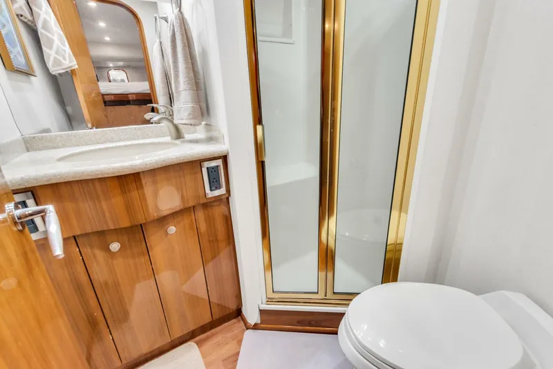 Berry Blessed Yacht Photos Pics Luxurious bathroom in 2005 Viking 74' Enclosed Bridge yacht with shower and vanity.