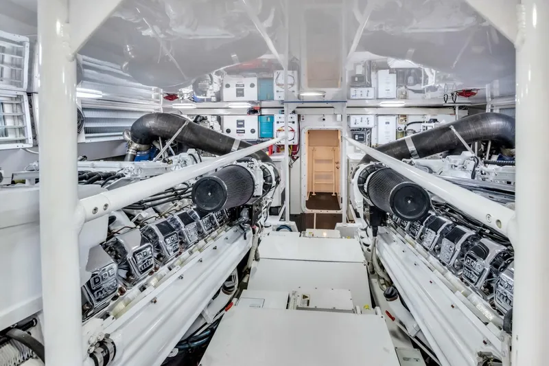 Berry Blessed Yacht Photos Pics Engine room of 2005 Viking 74' Enclosed Bridge yacht, showcasing dual engines and equipment.