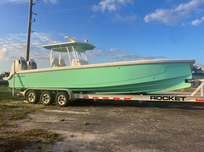 Yacht Photos Pics 2024 Dynamic D-305V boat on trailer under blue sky.