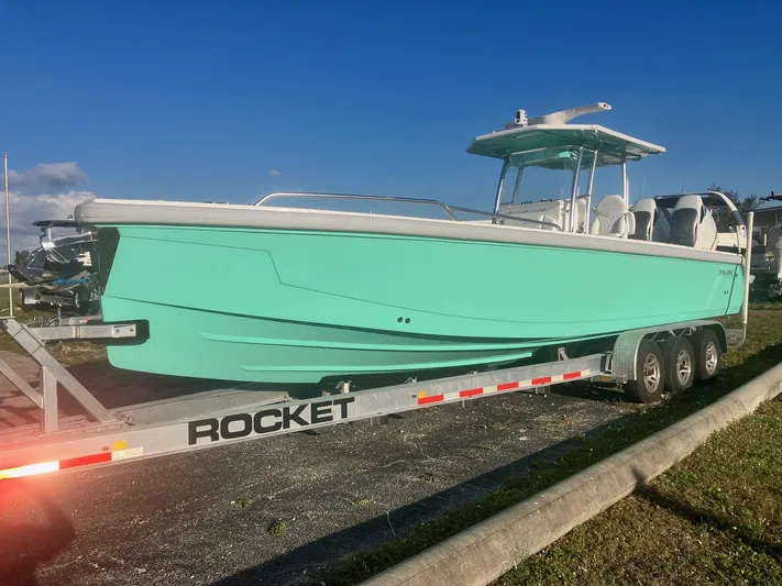  Yacht Photos Pics 2024 Dynamic D-305V boat on trailer, turquoise hull, sunny day.