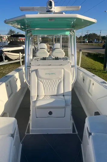  Yacht Photos Pics 2024 Dynamic D-305V boat with sleek design and modern seating, docked outdoors.