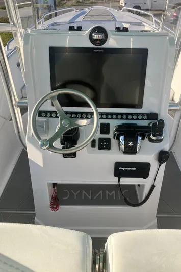  Yacht Photos Pics 2024 Dynamic D-305V boat console with steering wheel, touchscreen, and controls.