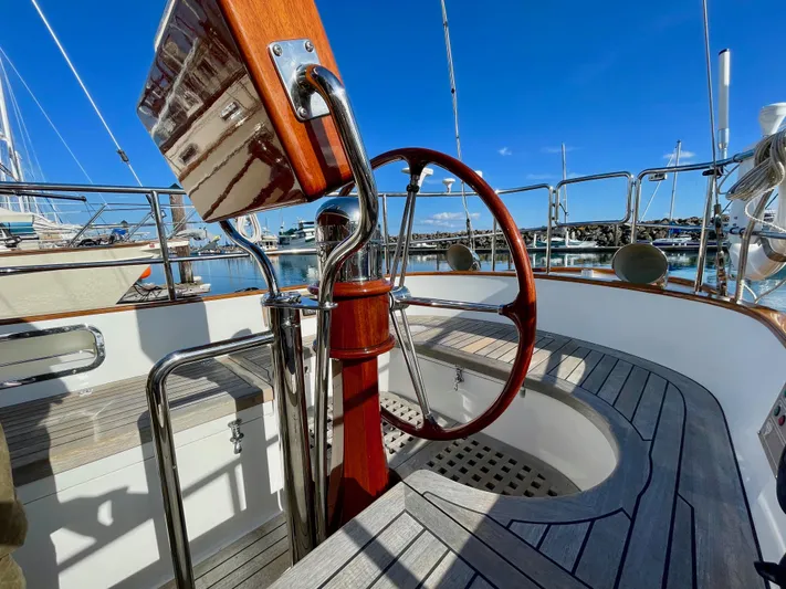 Robert Lewis Yacht Photos Pics Cockpit of 2018 Cape George 45 sailboat with wooden wheel and polished metal details.