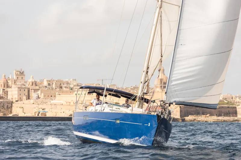 Pac Man Yacht Photos Pics Beneteau Oceanis Clipper 473 sailing near historic cityscape, 2001 model yacht.