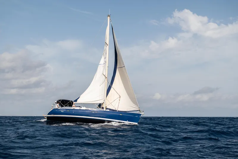 Pac Man Yacht Photos Pics Sailing yacht Beneteau Oceanis Clipper 473, 2001 model, cruising on open sea under clear skies.