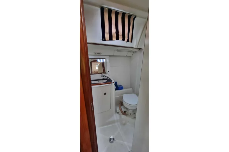 Pac Man Yacht Photos Pics Bathroom interior of 2001 Beneteau Oceanis Clipper 473 yacht, featuring toilet and sink.