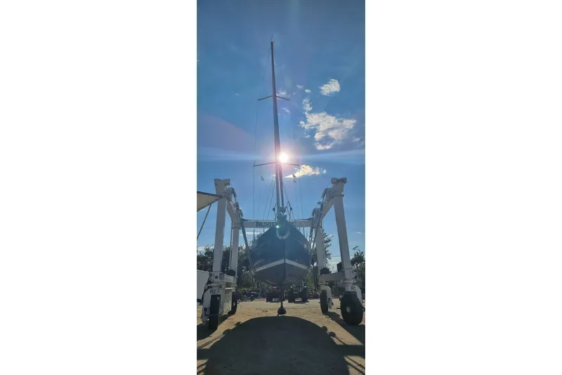 Pac Man Yacht Photos Pics Beneteau Oceanis Clipper 473 sailboat from 2001 on a lift under a bright sky.