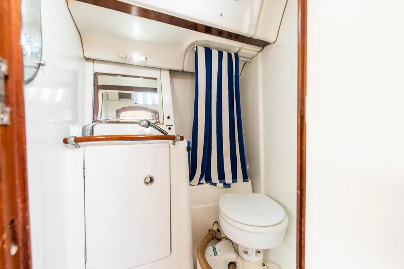 Pac Man Yacht Photos Pics Bathroom interior of 2001 Beneteau Oceanis Clipper 473 yacht with striped towel.
