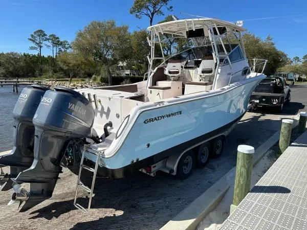  Yacht Photos Pics 2005 Grady-White Marlin 300 boat with twin Yamaha engines at a dock.