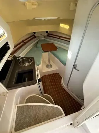  Yacht Photos Pics 2005 Grady-White Marlin 300 cabin interior with kitchenette and seating area.