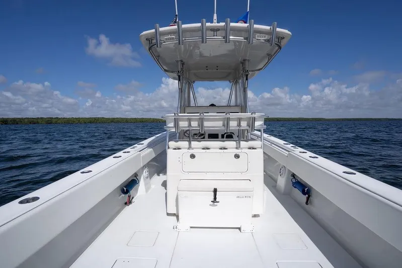  Yacht Photos Pics 2013 Contender 32 ST boat on open water under clear blue sky.