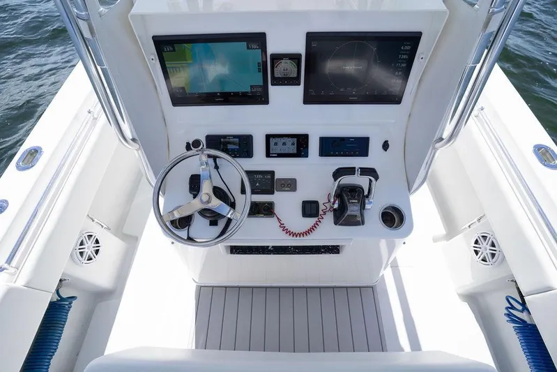  Yacht Photos Pics 2013 Contender 32 ST boat console with steering wheel and navigation screens.