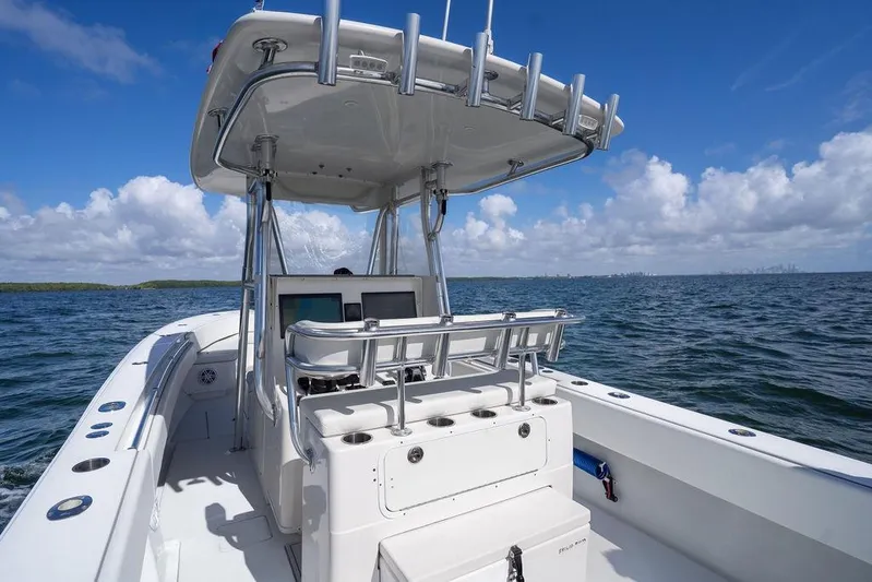  Yacht Photos Pics 2013 Contender 32 ST boat on open water under a clear blue sky.