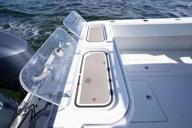  Yacht Photos Pics 2013 Contender 32 ST boat deck with storage compartments and dual outboard engines.