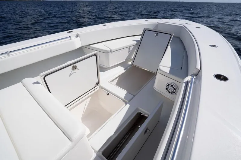  Yacht Photos Pics 2013 Contender 32 ST boat with open storage compartments on a sunny day at sea.