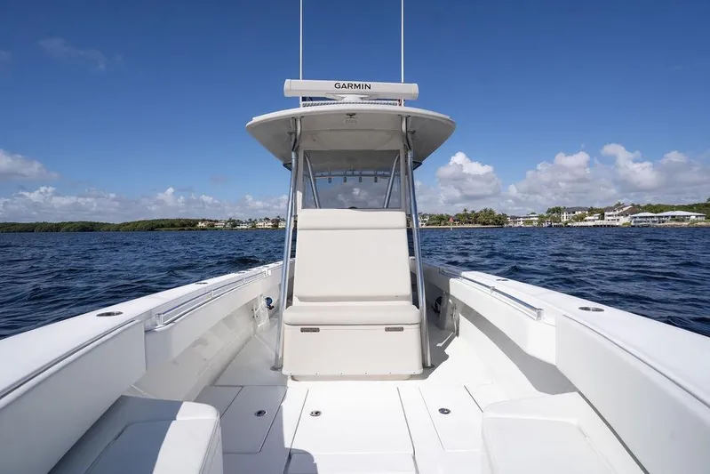  Yacht Photos Pics 2013 Contender 32 ST boat on open water under clear blue sky.