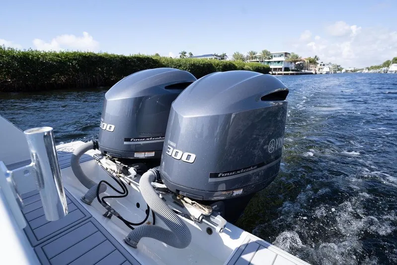  Yacht Photos Pics Twin Yamaha 300 outboard engines on a 2013 Contender 32 ST boat cruising on water.