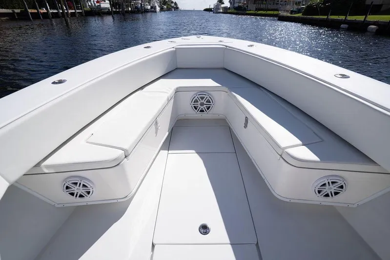 Yacht Photos Pics 2013 Contender 32 ST boat interior with white seating and speakers on a sunny day.