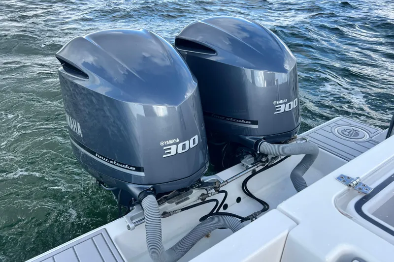  Yacht Photos Pics Twin Yamaha 300 outboard engines on a 2013 Contender 32 ST boat in water.