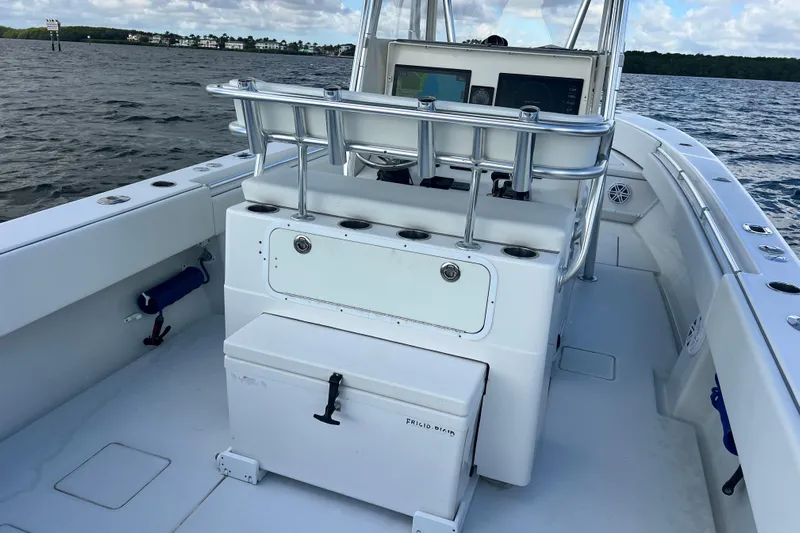  Yacht Photos Pics 2013 Contender 32 ST boat interior with console and seating, on calm waters.