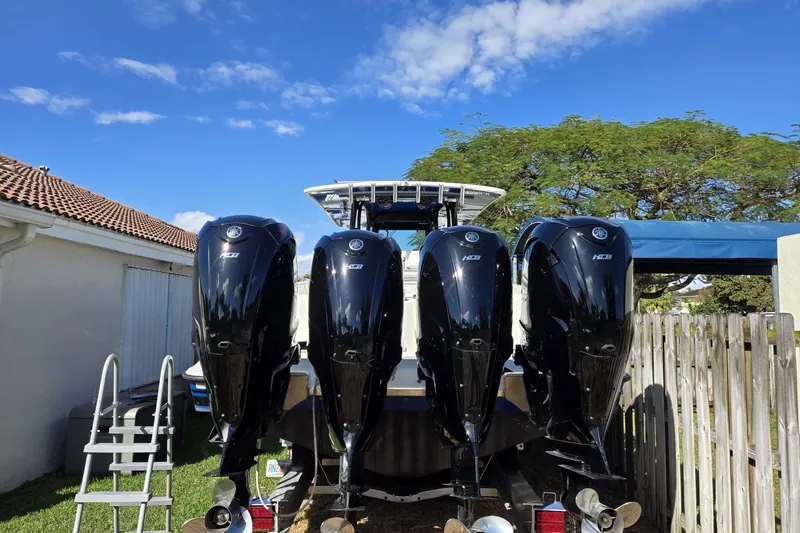  Yacht Photos Pics 2017 HCB 42 Siesta boat with four powerful outboard engines, parked outdoors.