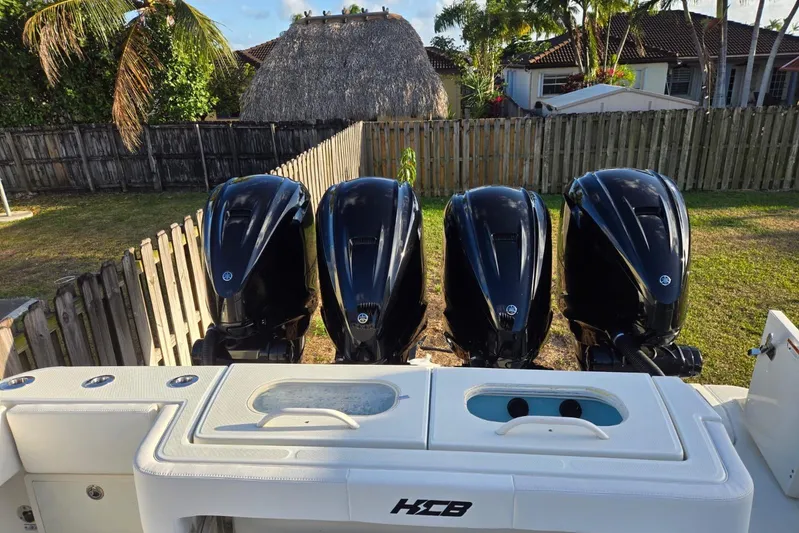  Yacht Photos Pics 2017 HCB 42 Siesta boat with four powerful outboard engines in a backyard setting.